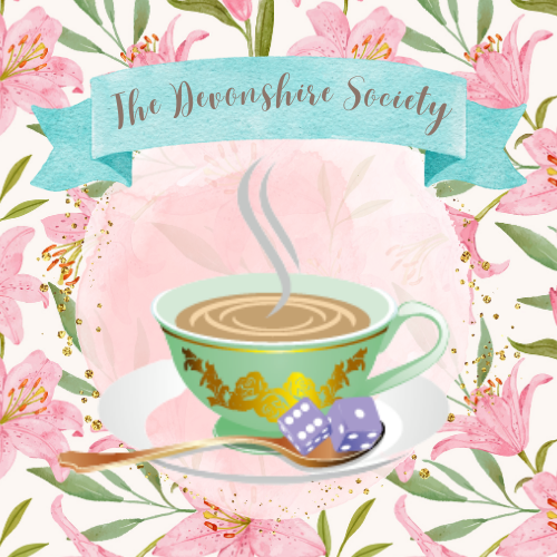 Devonshire Society logo. A green and gold tea cup sits on a dish with dice resting in a golden teaspoon . A pink flower pattern sits in the background and a blue banner sits above with the text "The Devonshire Society"